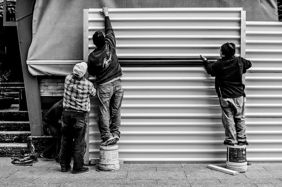Grayscale Photo of Three Men Arranging Metal Wall, real people HD wallpaper