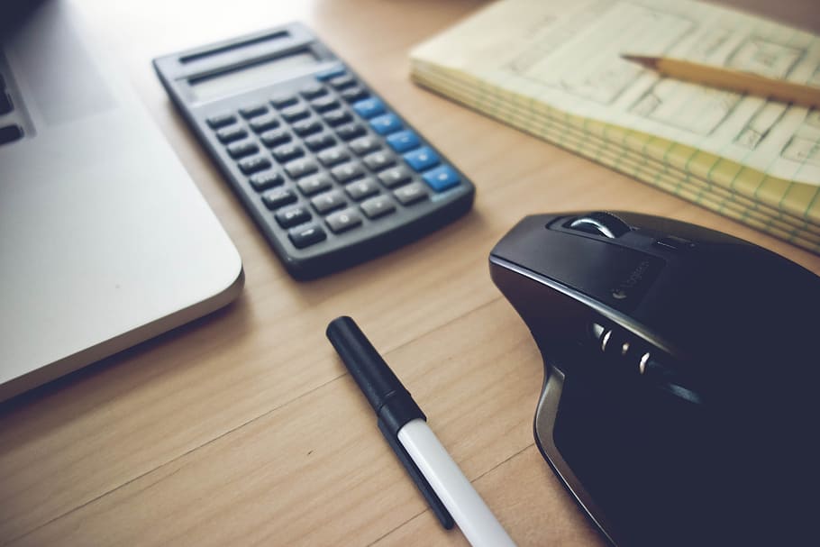 Home Office Setup Essentials Toolkit. Laptop, Wireless Mouse, Notepad and a Calculator. HD wallpaper