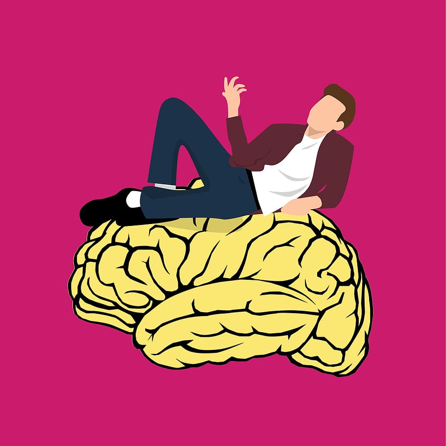 Man perched on illustration of human brain, thinking., mindset