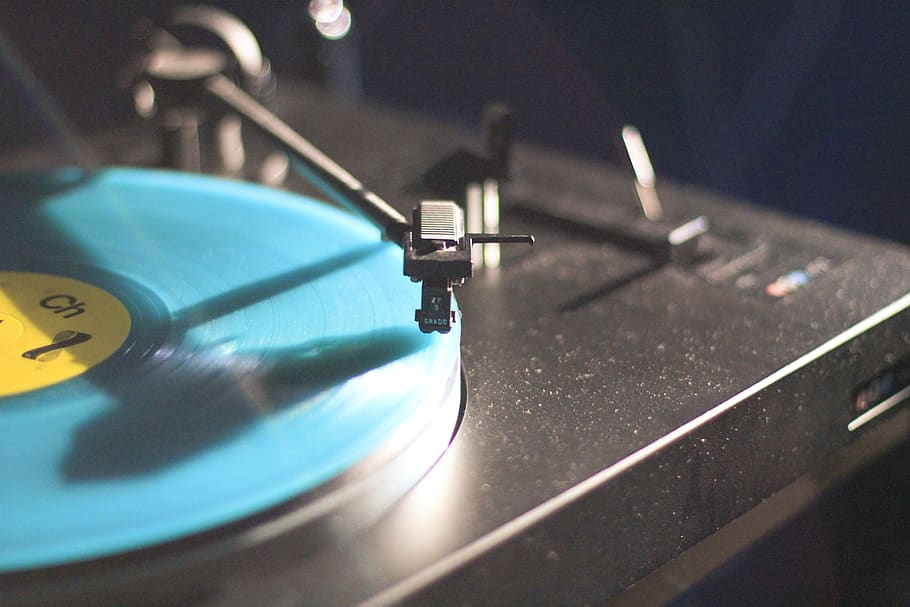 blue vinyl record playing, candle, disk, pin, clock, alarm clock