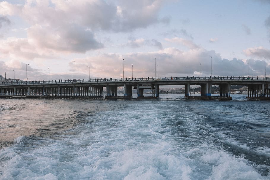 People Standing on Gray Concrete Bridge Above Water, beach, clouds HD wallpaper