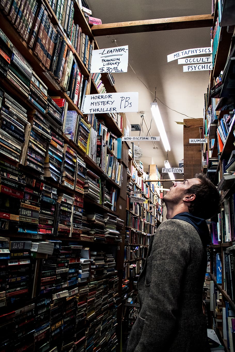 man standing beside book shelf, real people, one person, lifestyles HD wallpaper
