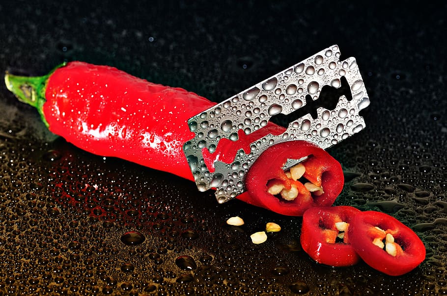 Red Chili Pepper Sliced by a Blade, moist, razor blade, seeds, HD wallpaper
