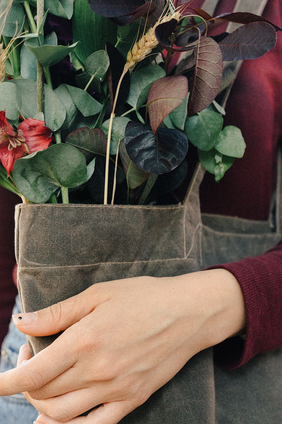 woman carrying brown tote bag with flower, plant, hand, fashion