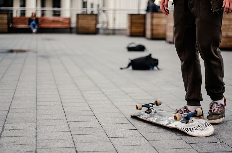 person standing near white and black skateboard, backpack, skater HD wallpaper