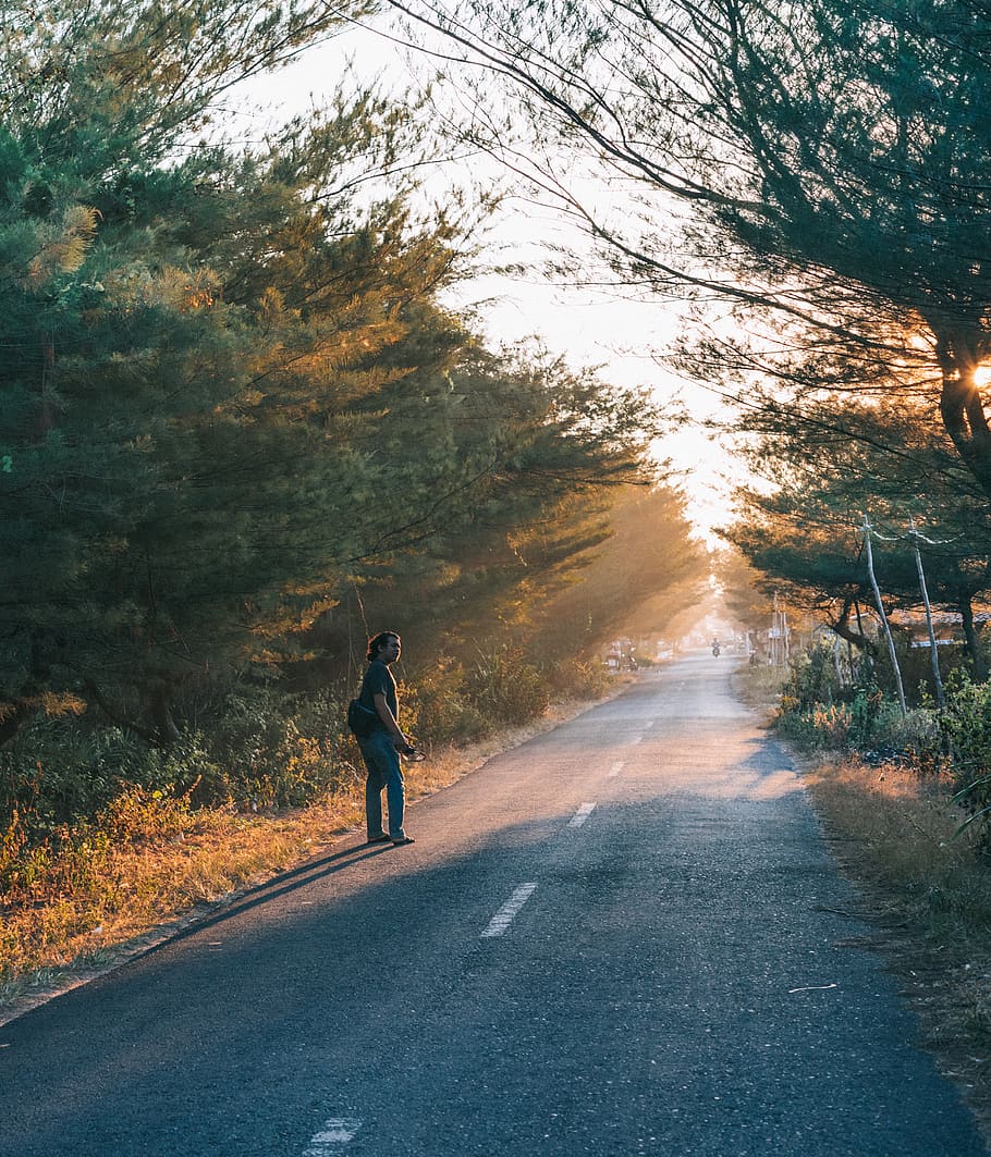 Man Wearing Black Shirt and Blue Pants on Side of Asphalt Road HD wallpaper