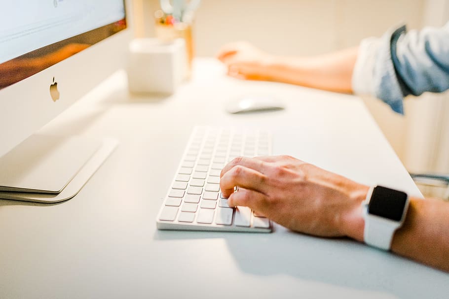 person using iMac, human hand, human body part, technology, table HD wallpaper