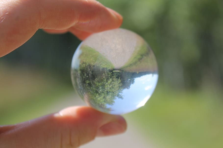 human hand, holding, human body part, sphere, one person, focus on foreground HD wallpaper