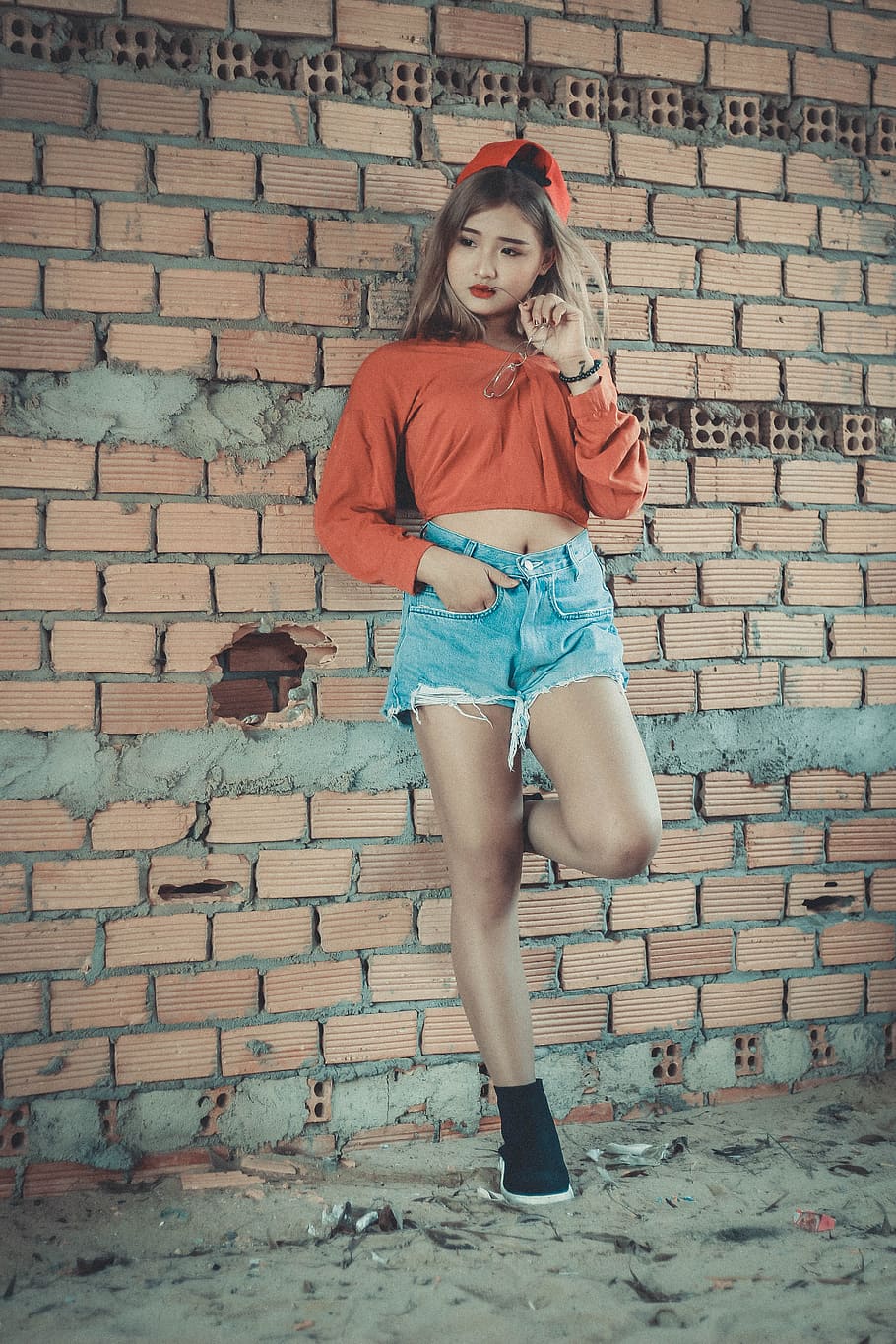 Photo of Woman Wearing Orange Crop-top Near Brown Concrete Brick Wall, HD wallpaper