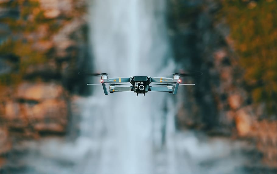 selective focus photography of quadcopter drone, flying drone