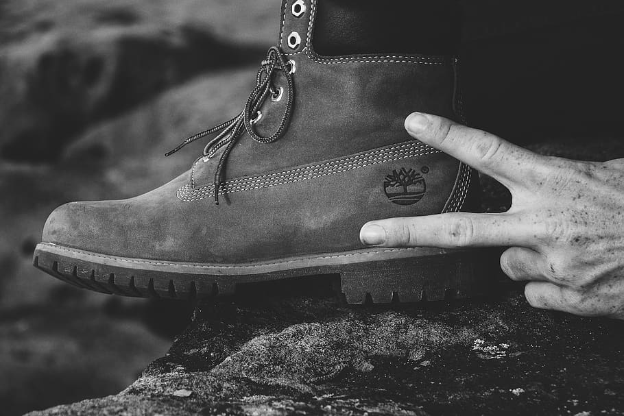 grayscale photography of person wearing Timberland work boot