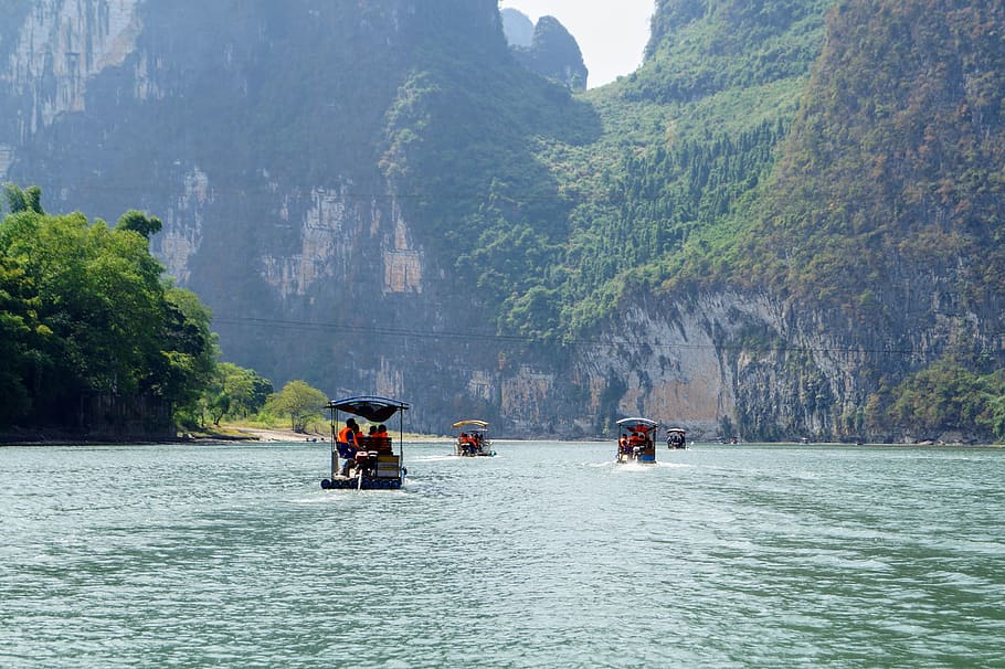 people riding on boat during daytime, china, 095 county rd, guilin shi
