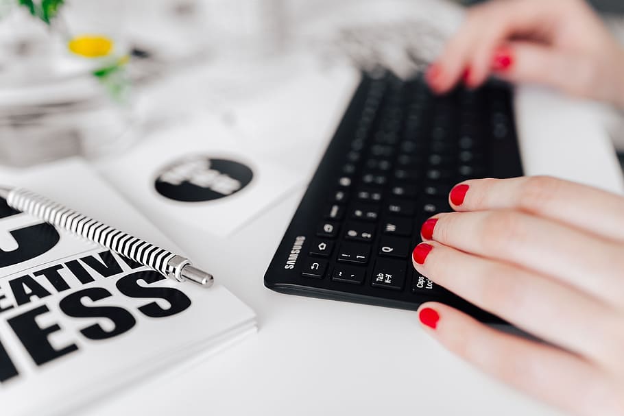 Female hands typing on the remote wireless computer keyboard HD wallpaper