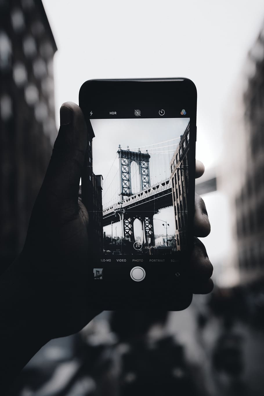 HD wallpaper: grayscale photography of person holding iPhone capturing  bridge | Wallpaper Flare