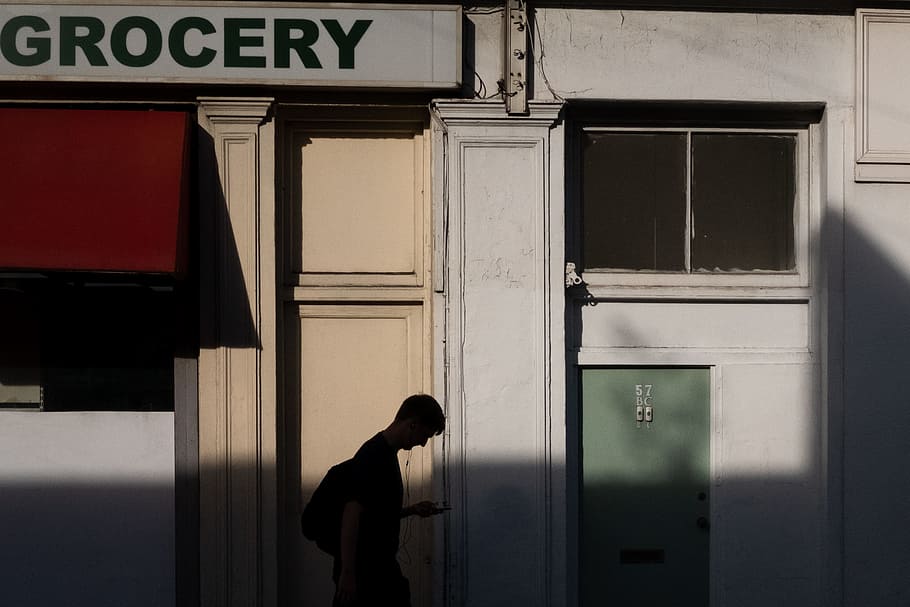 man holding smartphone, shadow, silhouette, green, red, streetphotography HD wallpaper