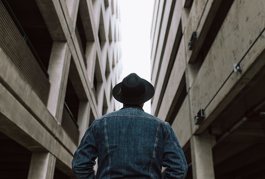 man standing between two buildings, rear view, architecture, built structure HD wallpaper