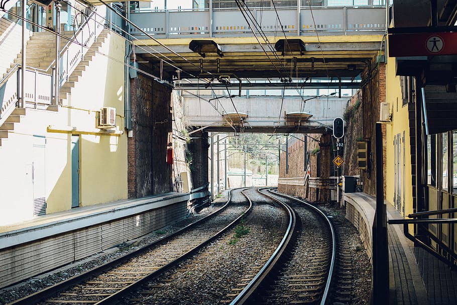 Gray Train Rail Under Yellow and Gray Building, daytime, iron HD wallpaper