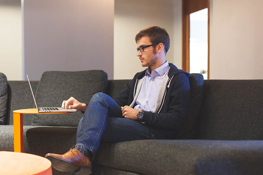 Man Sitting on Black Couch, apple, casual, digital nomad, fashion HD wallpaper