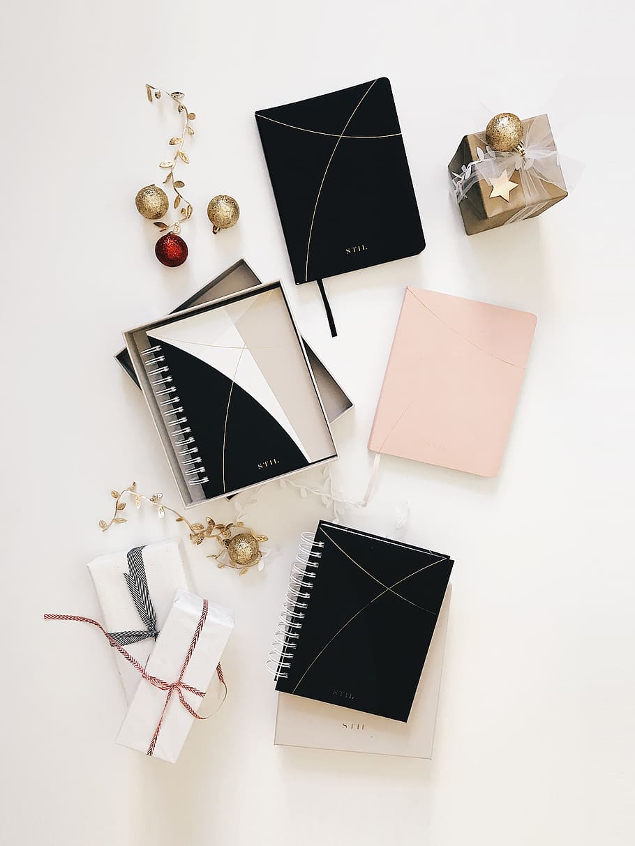 black spiral notebook on white surface, still life, high angle view HD wallpaper