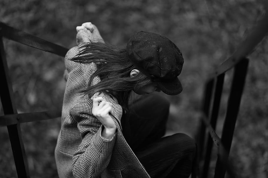 people, cap, coat, sitting, outside, black and white, focus on foreground HD wallpaper