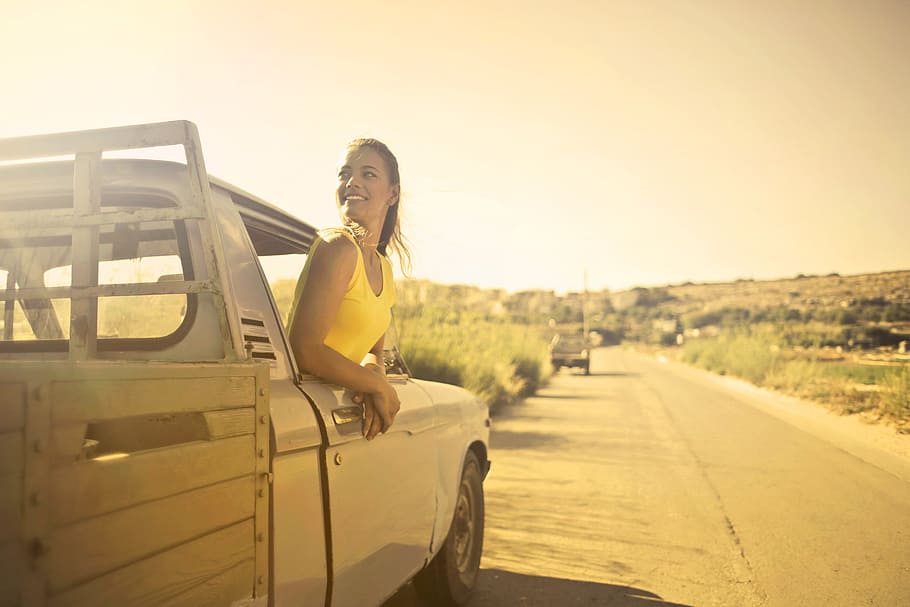 Young Beautiful Woman in Yellow Polo Shirt looking out from driver seat window of pick up truck, HD wallpaper
