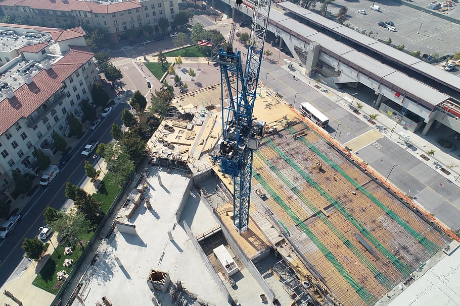 tower crane in between building under construction, high angle view HD wallpaper