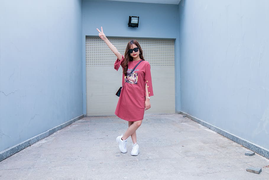 Woman Wearing Red Long-sleeved Dress Standing in Front of Shutter Door HD wallpaper