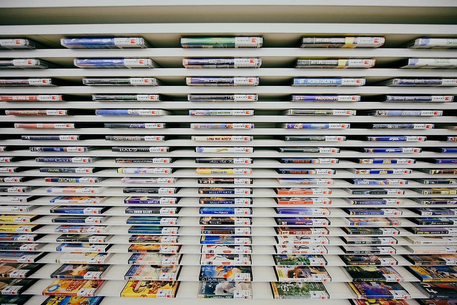 game case collection on shelf, large group of objects, multi colored HD wallpaper