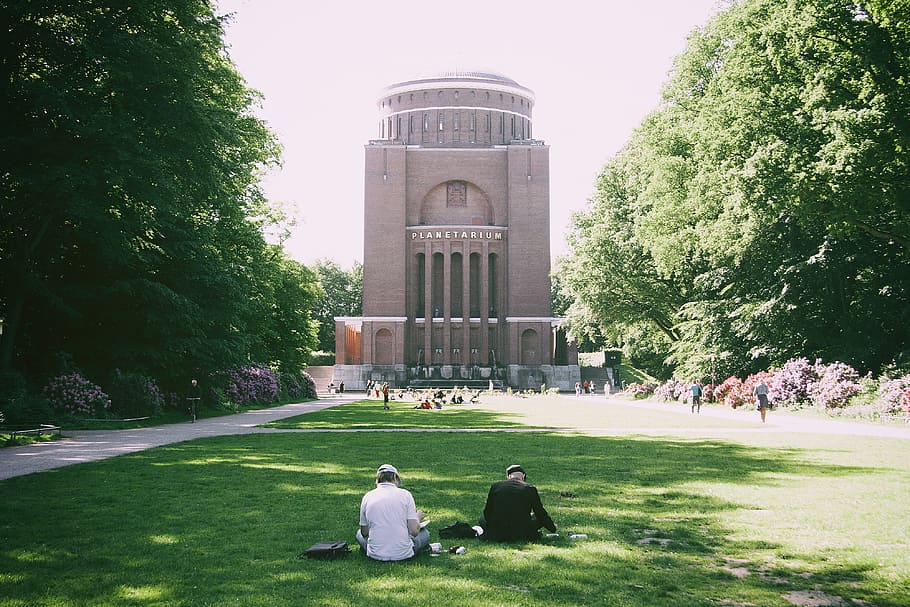 Sitting on grass in park, architecture, building, campus, casual