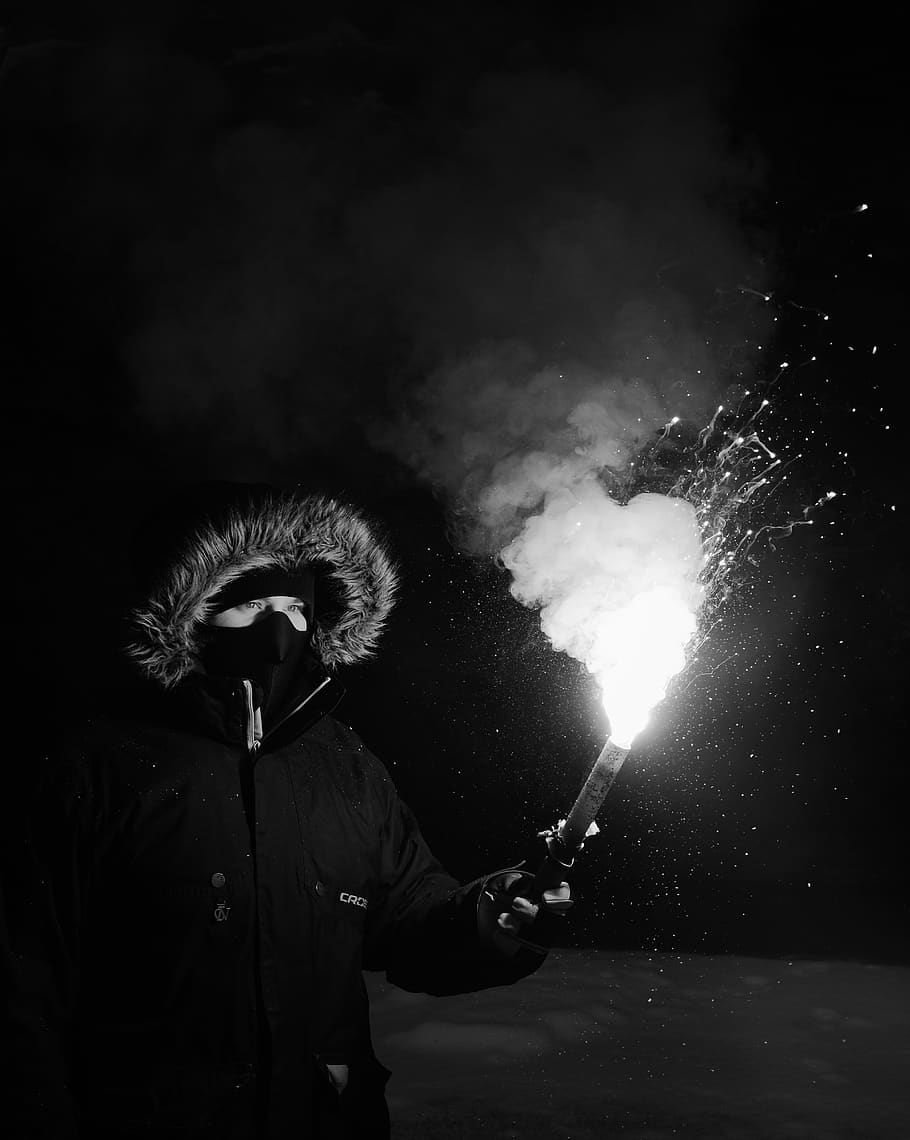 Person Wearing Coat Holding Firework, black and white, black-and-white