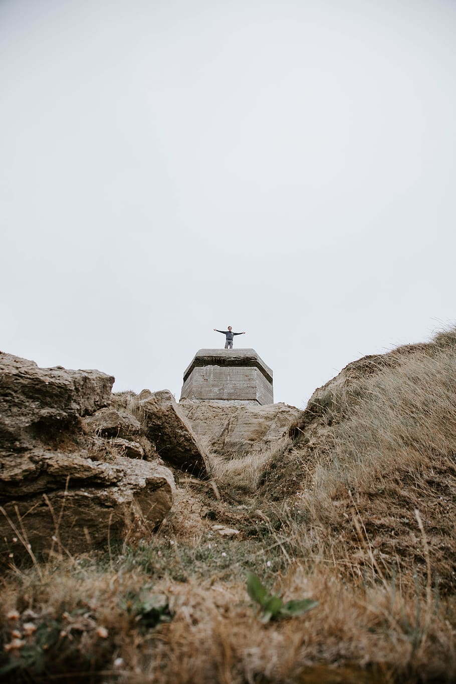 low-angle photography of man standing on stone with arms wide-open statue, HD wallpaper