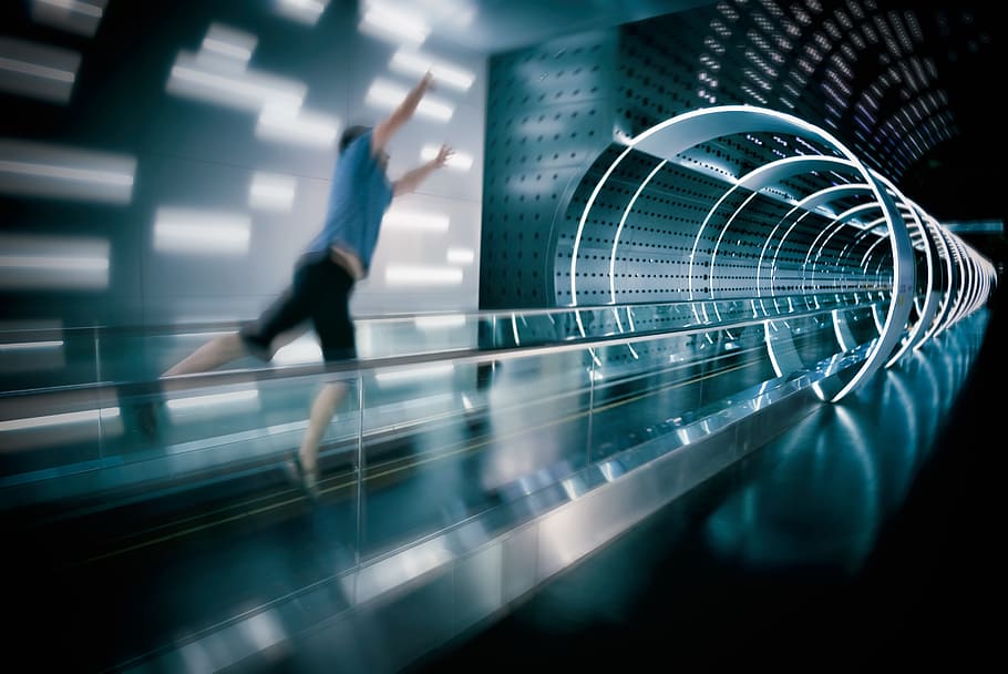 man jumps on escalator, city, speed, fast, technology, movement