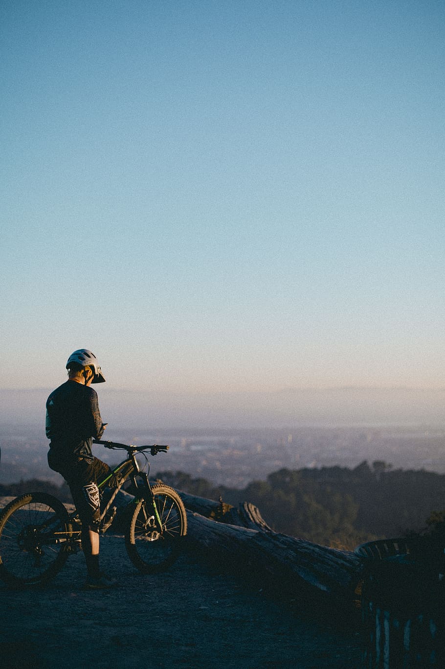 man riding on bicycle while standing on peak, sky, real people HD wallpaper