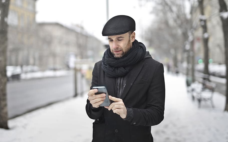 Man Operating Smartphone, fashion, guy, interaction, outerwear HD wallpaper