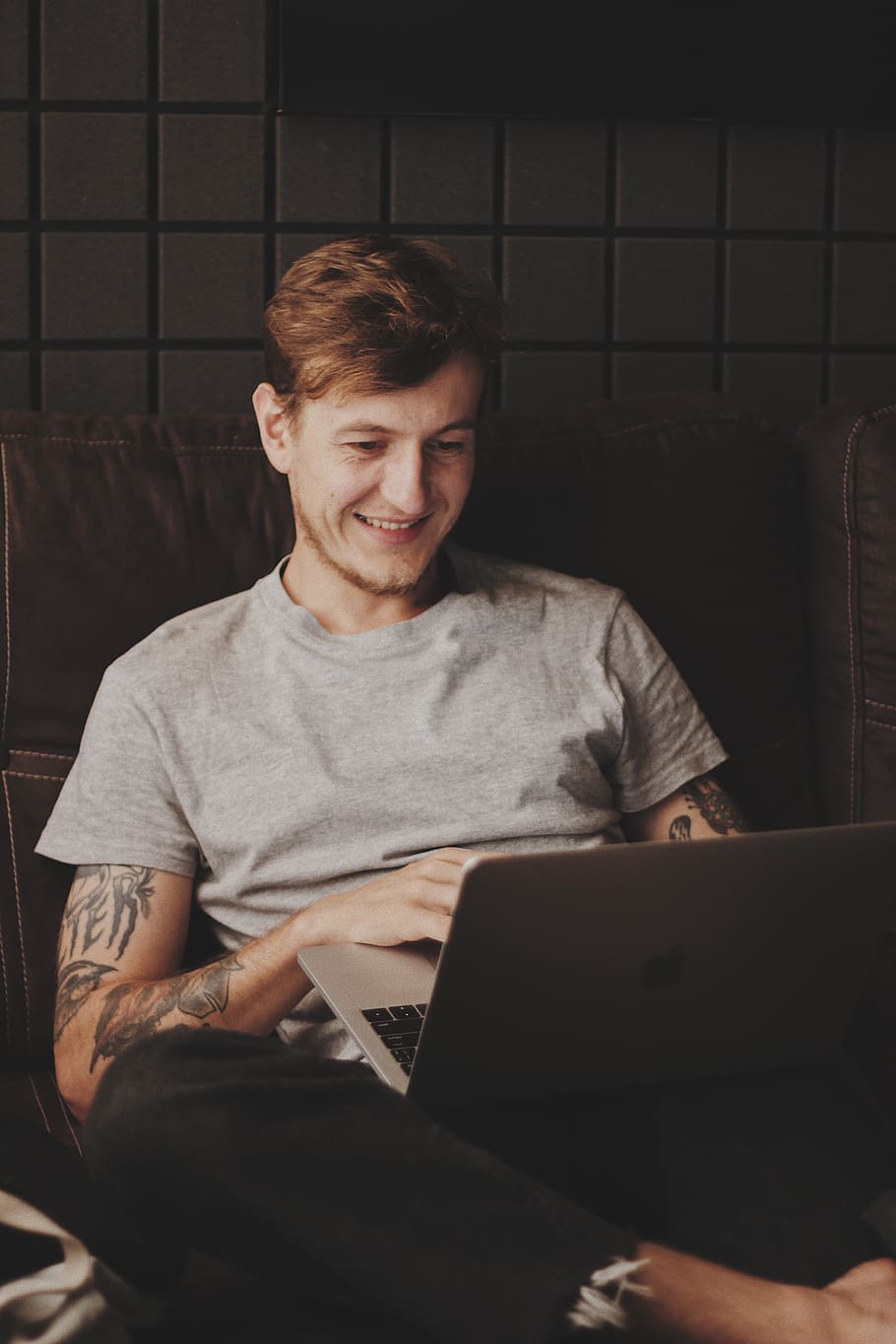 man sitting facing silver MacBook inside room, one person, front view HD wallpaper