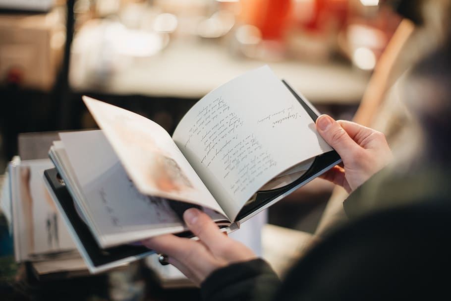 person open book page, paper, one person, holding, selective focus HD wallpaper