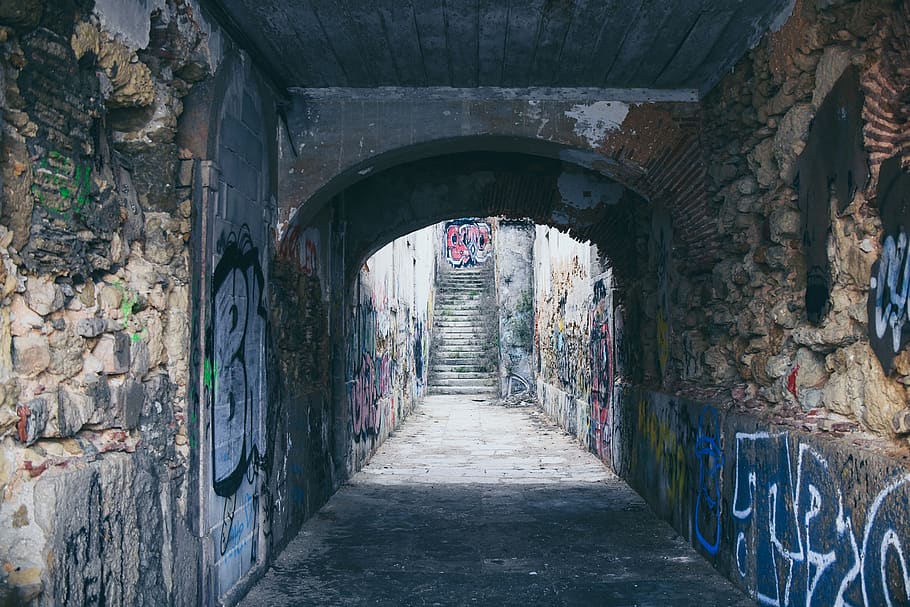 empty tunnel filled with graffiti during daytime, path, walkway