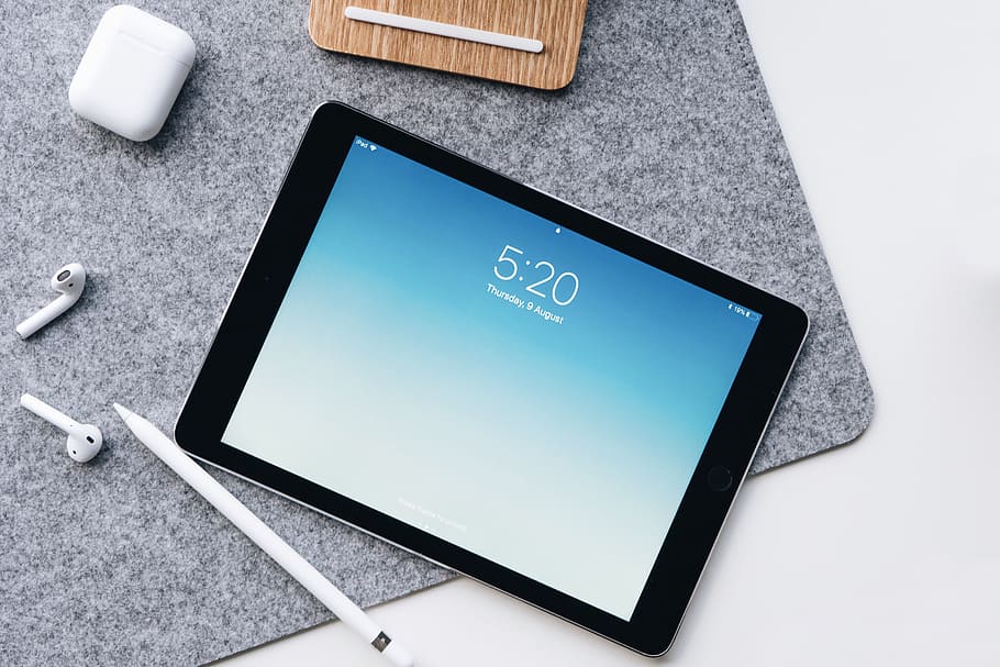 black iPad beside Apple Pencil and AirPods on gray mat, tablet, HD wallpaper