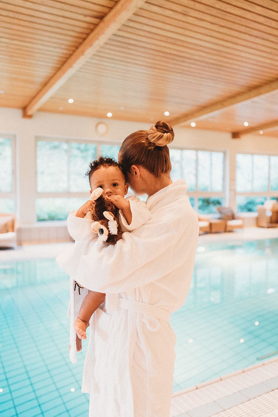 woman wearing white robe carrying baby, quality time, family time