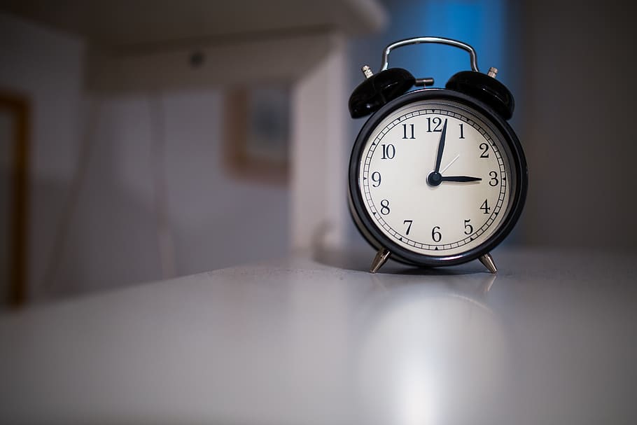Black and White Alarm Clock Diplaying at 3:03 on White Wooden Surface HD wallpaper