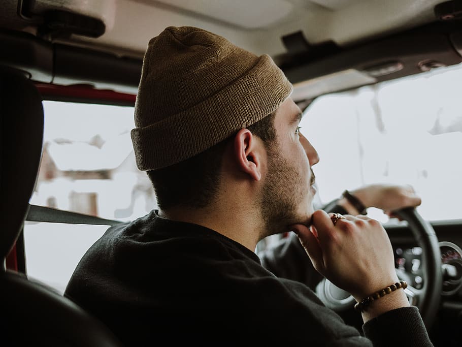 man driving while touching his chin, person, human, clothing HD wallpaper