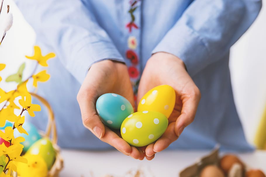 Hands holding modern painted easter eggs., multi colored, one person HD wallpaper