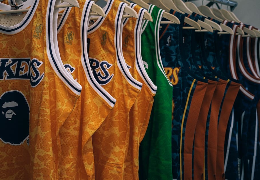 assorted NBA jerseys hanged on clothes hangers, apparel, clothing