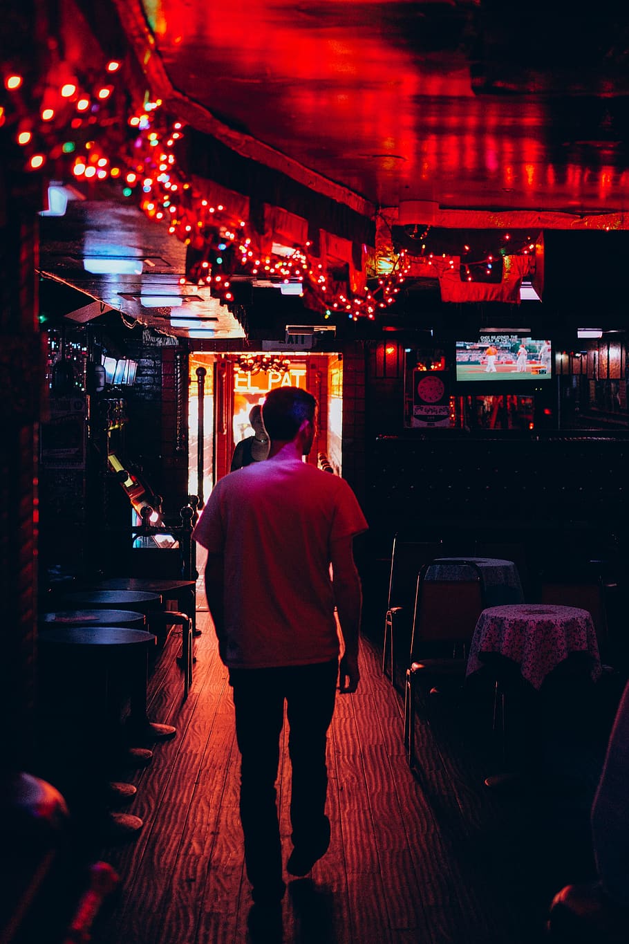 man walking inside room, night, illuminated, rear view, city HD wallpaper