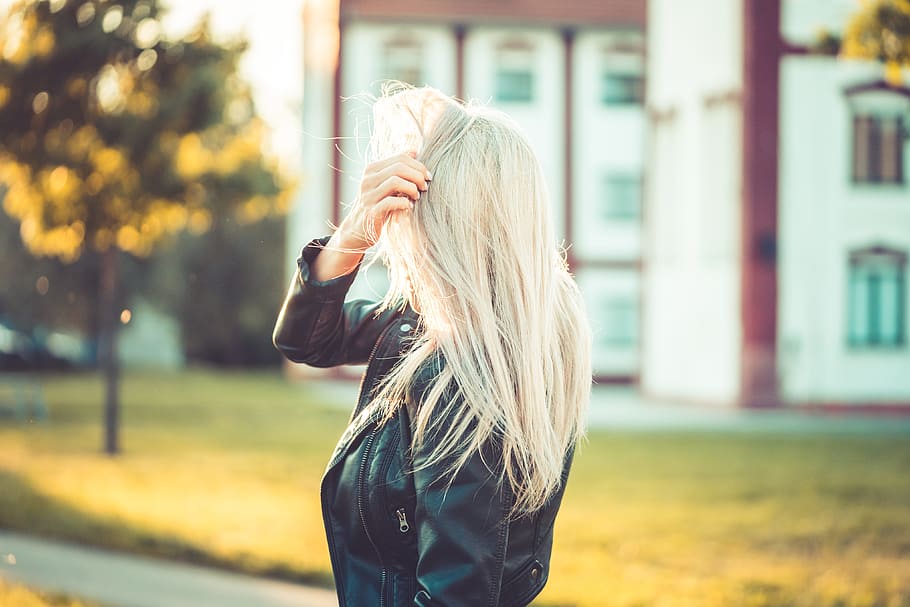 Blonde Woman Playing with Hair Against Sun, alone, emotions, evening