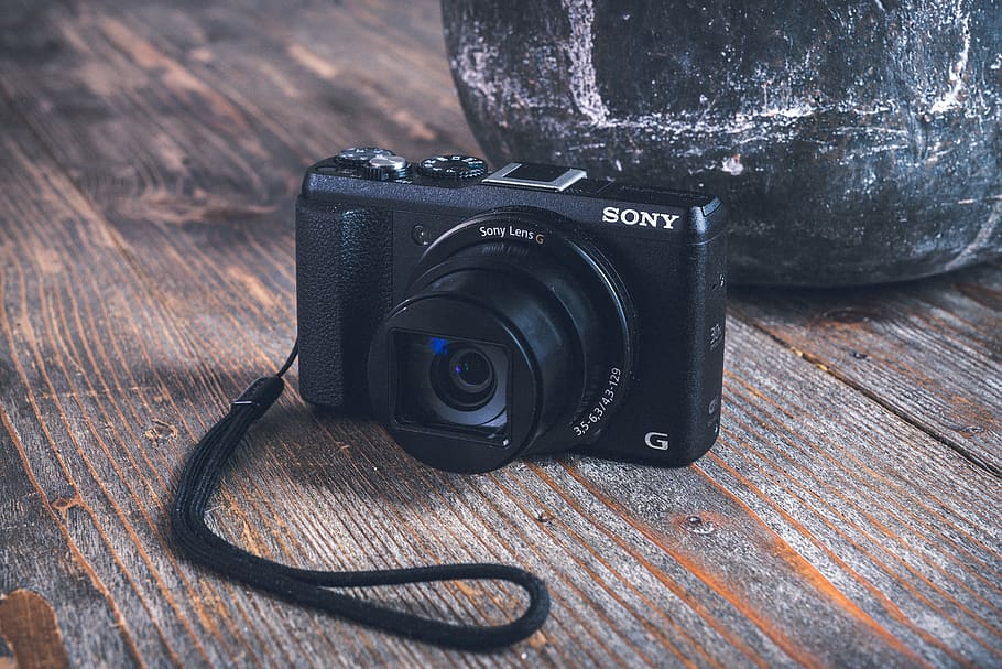 black Sony digital camera on table, strap, electronics, point and shoot HD wallpaper