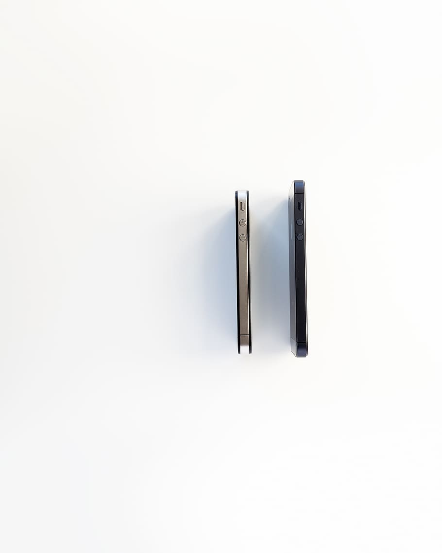 two space gray and silver iPhone 5s, white background, studio shot HD wallpaper