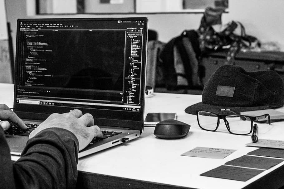 grayscale photo of man using laptop coding, table, technology HD wallpaper