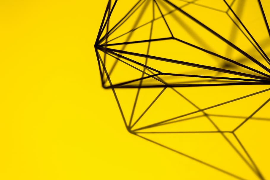 Geometric decoration on yellow background, texture, studio shot HD wallpaper