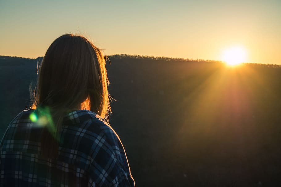 Woman Wearing Plaid Shirt Facing Sun during Golden Hour, backlit HD wallpaper